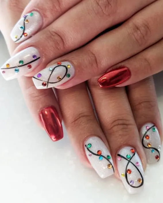 Chic short nails featuring Christmas light-inspired gems and a standout metallic red