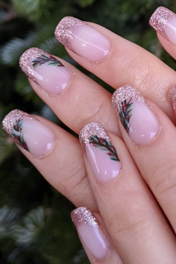 Soft pink nails with glittery tips and subtle garland designs.