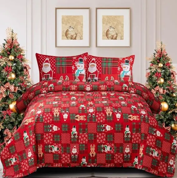 A vibrant red Christmas-themed bedding set featuring Santa Claus and reindeer.