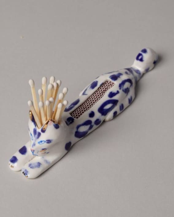  A Dalmatian-patterned matchstick holder on grey counter.