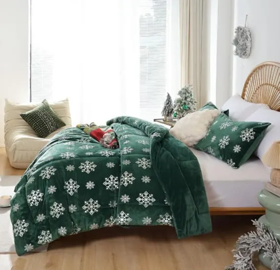 A soft velvet Christmas bedding set in emerald green with a snowflake design.