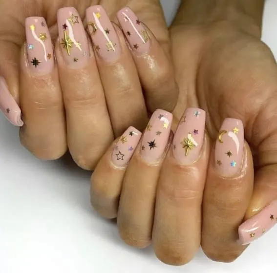 Short nails with pastel pink base and delicate gold star accents