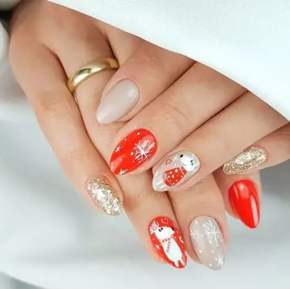 Short nails with a mix of Christmas designs including snowflakes, white reindeer, and glitter