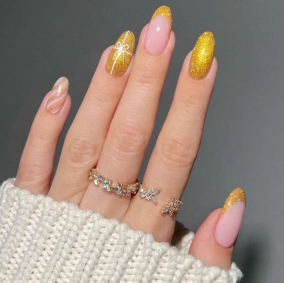 Gold glitter nails with a creative Christmas design.