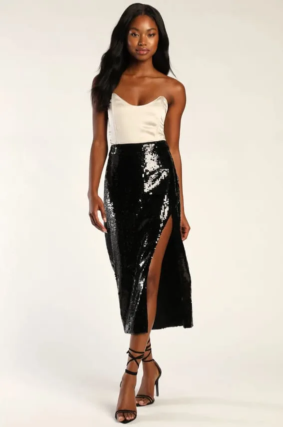 Outfit with a glamorous black sequin skirt featuring a thigh-high slit, paired with a sleek ivory satin camisole.