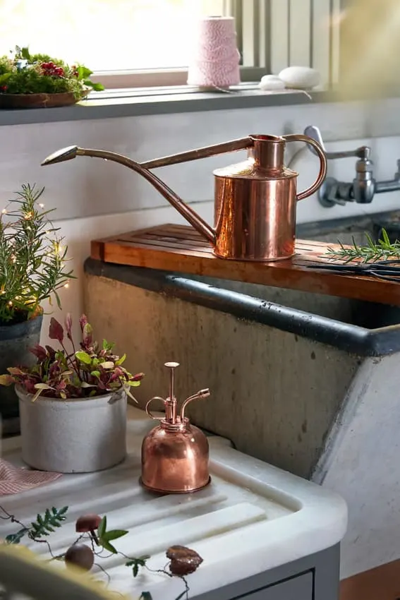 A stunning copper watering can and mister, designed for both utility and style.