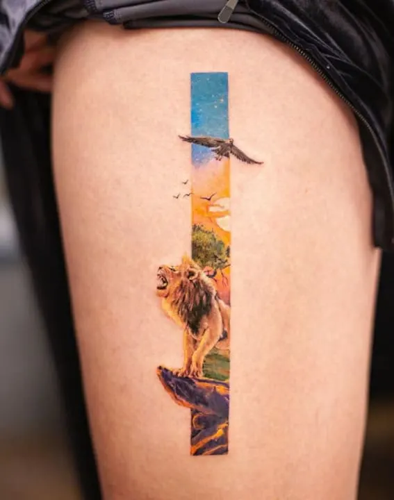 A tattoo showcasing a lion in a vibrant, nature-themed vertical strip on a person's leg