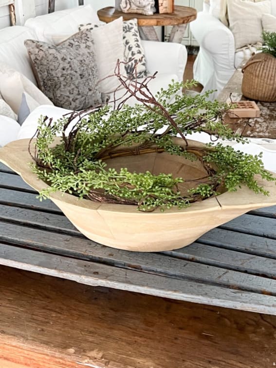 Dough bowl brimming with fresh greenery and whimsical twigs wreath