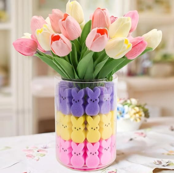 Glass vase with Easter Peeps bunnies supporting a lively arrangement of tulips.
