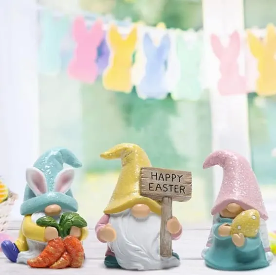 Set of three Easter gnomes featuring glittery hats holding carrots, eggs, and a sign saying 'Happy Easter".