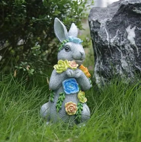 Solar garden statue of a bunny with floral accents, outdoor decor.