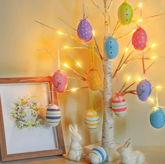 Easter decoration with lighted birch tree and colorful egg ornaments.