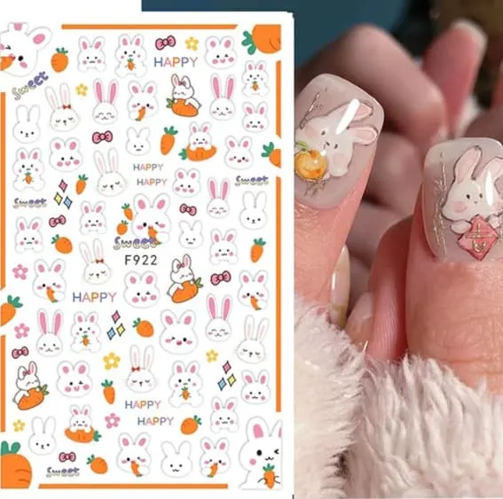 Sheet of Easter-themed nail stickers featuring bunnies and flowers and a hand displaying them.