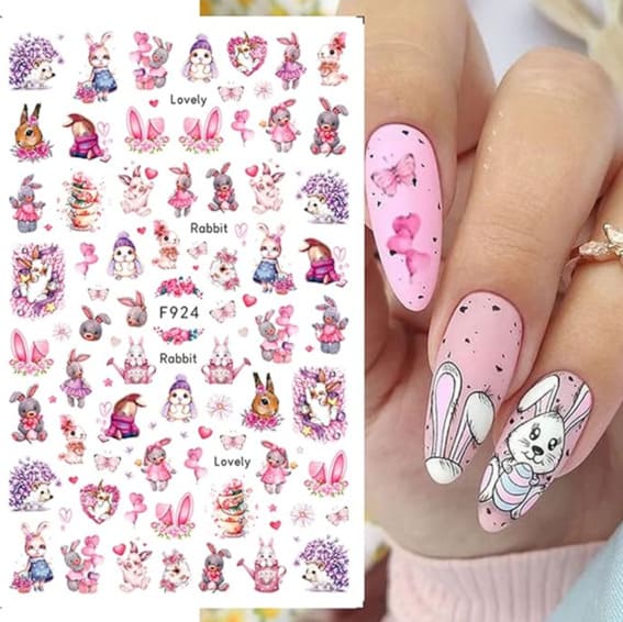 Sheet of Easter-themed nail stickers featuring bunnies and flowers and a hand displaying them.