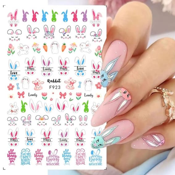 Sheet of Easter-themed nail stickers featuring bunnies and flowers and a hand displaying them.