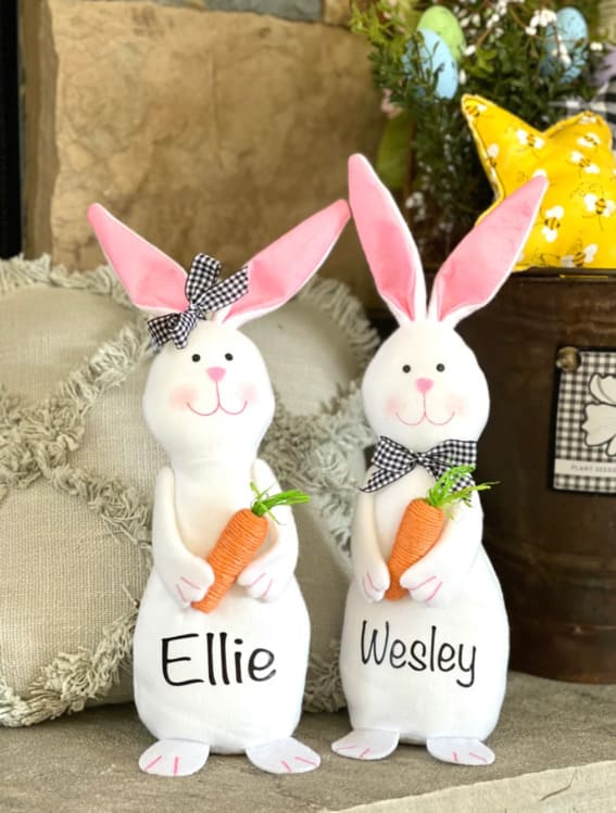 Customizable plush bunnies holding carrots with the names 'Ellie' and 'Wesley' on them.
