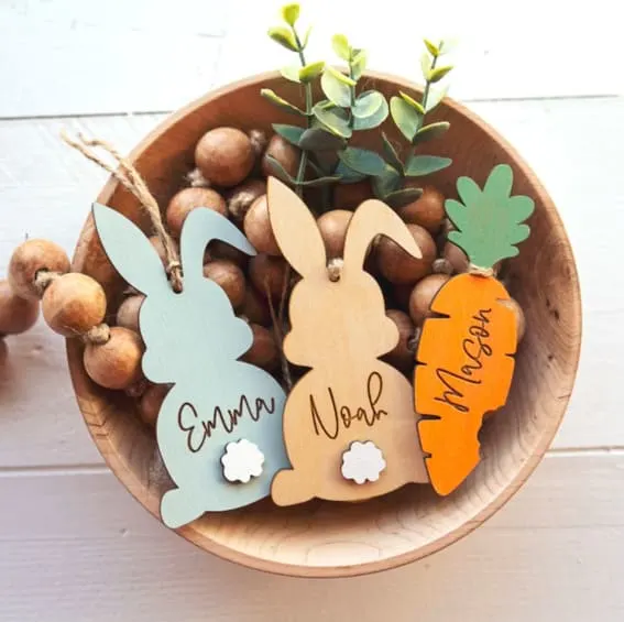 Personalized wooden bunny and carrot name tags in a bowl with beads