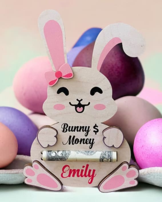 A personalized wooden bunny money holder with 'Emily' script amidst a backdrop of colorful Easter eggs.