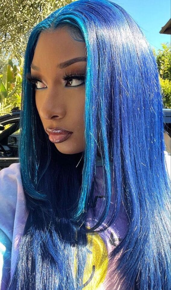 Glistening blue locks transitioning from midnight blue to cerulean reflect the vibrant brilliance of an azure glow.