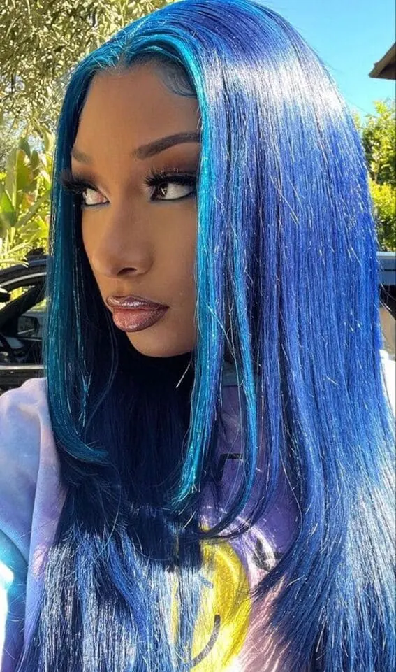 Glistening blue locks transitioning from midnight blue to cerulean reflect the vibrant brilliance of an azure glow.