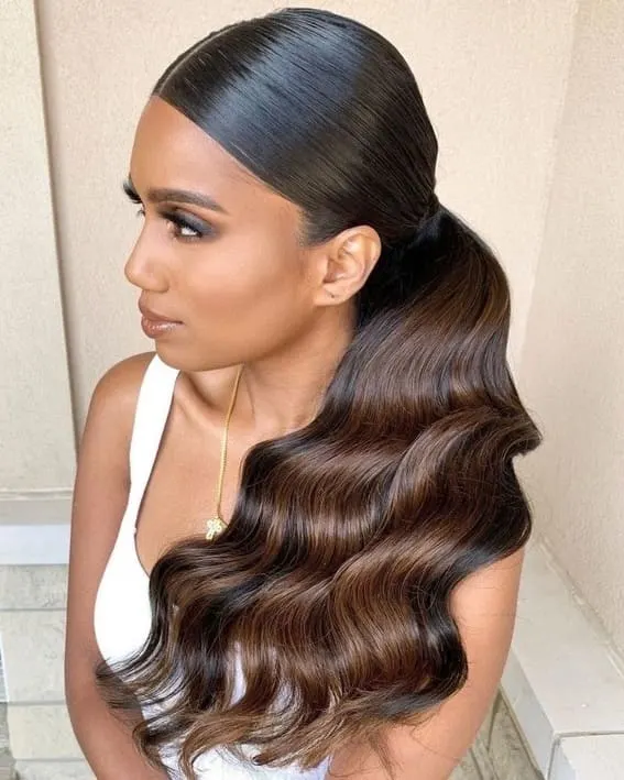 A woman with a sleek ponytail that is transforming into flowing waves.
