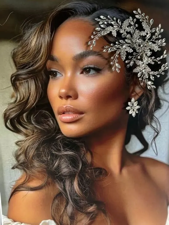 Bride with voluminous curls and a sparkling flower hairpiece.