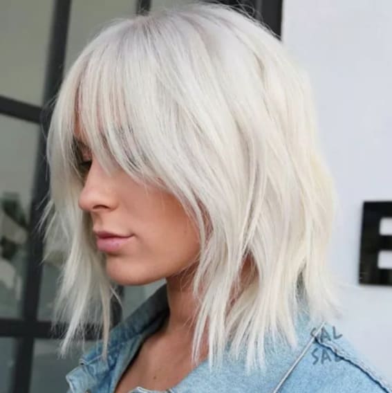 Layers, curtain bangs, and cool platinum color define this straight shag.