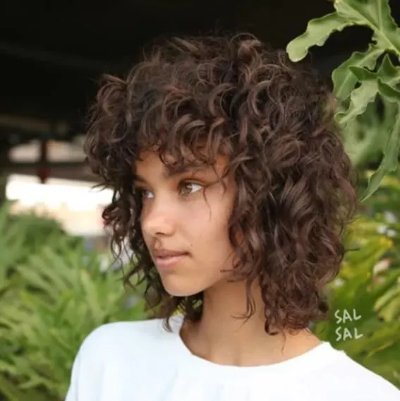 Embrace your natural texture with glorious layers that let curls run wild.