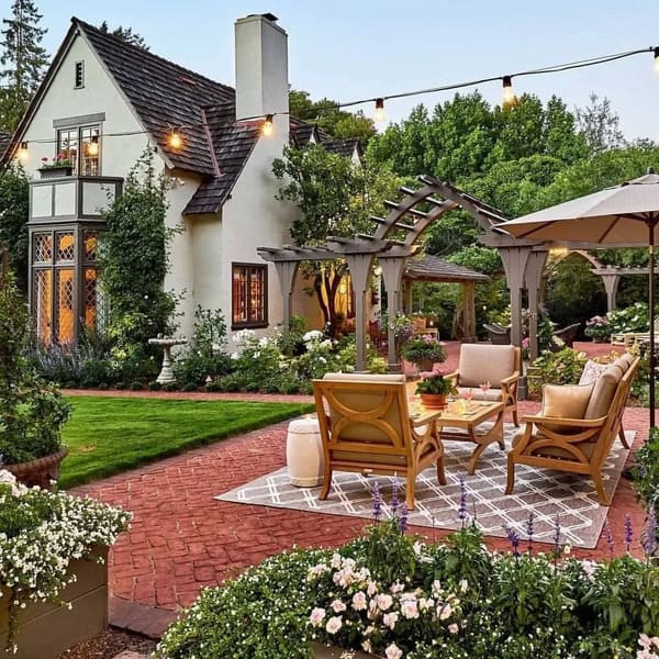 Elegant patio decor with wooden seating, pergola, and garden string lights