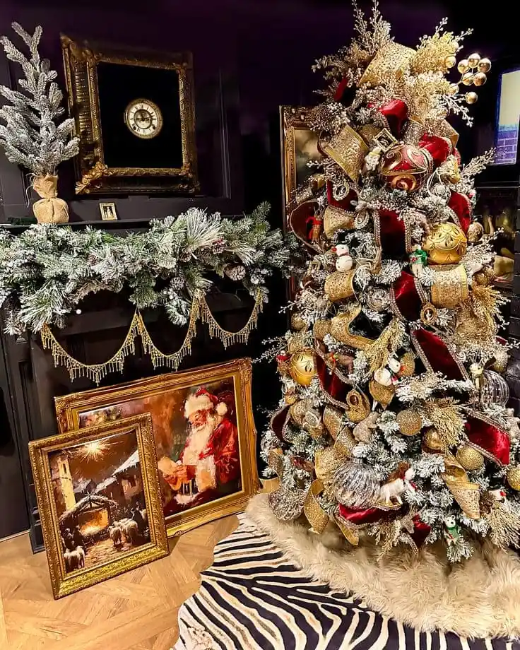 Ralph Lauren–style Christmas—frosted tree with gold + deep-red velvet ribbon, antique gilded frames, tassel-trimmed garland, zebra rug in a dark paneled room.