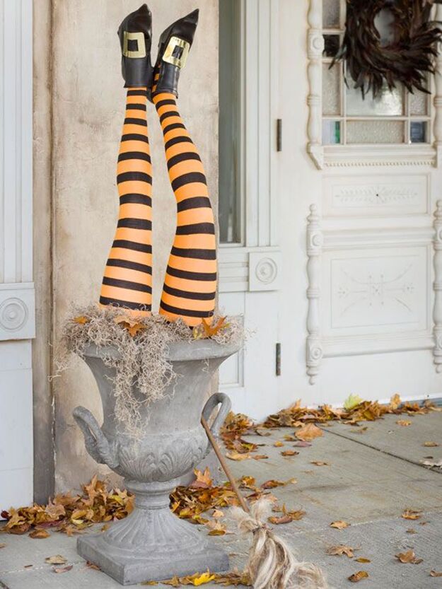 Halloween porch planter with orange and black witch legs and black boots