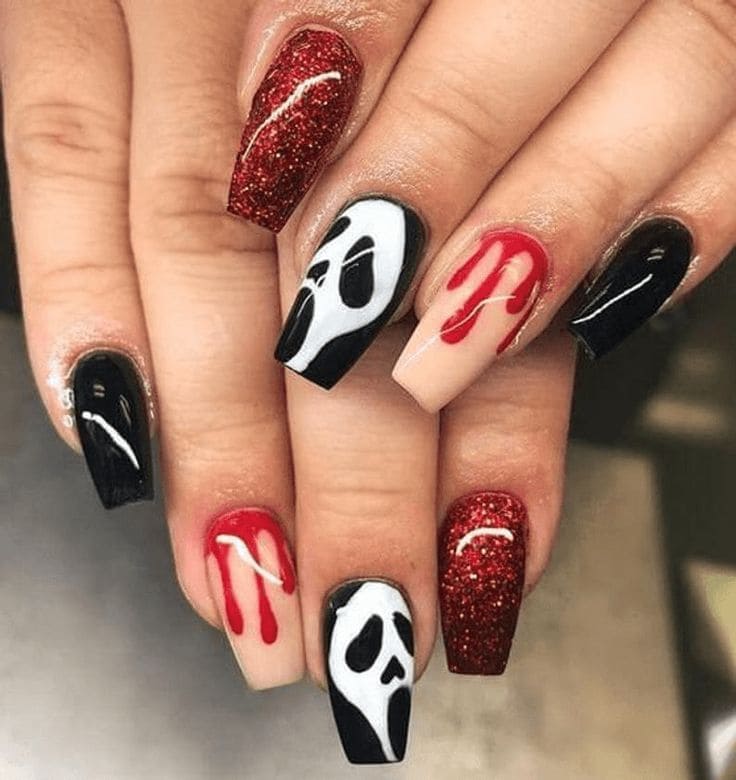Halloween coffin nails with Scream face art, red drip nail design, black polish, and red glitter