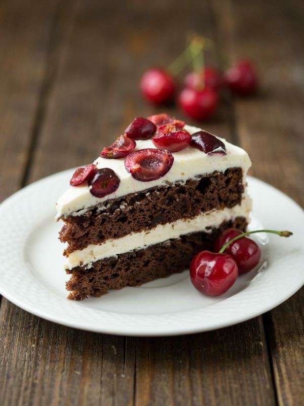 Chocolate cherry cake with cream frosting and fresh cherries