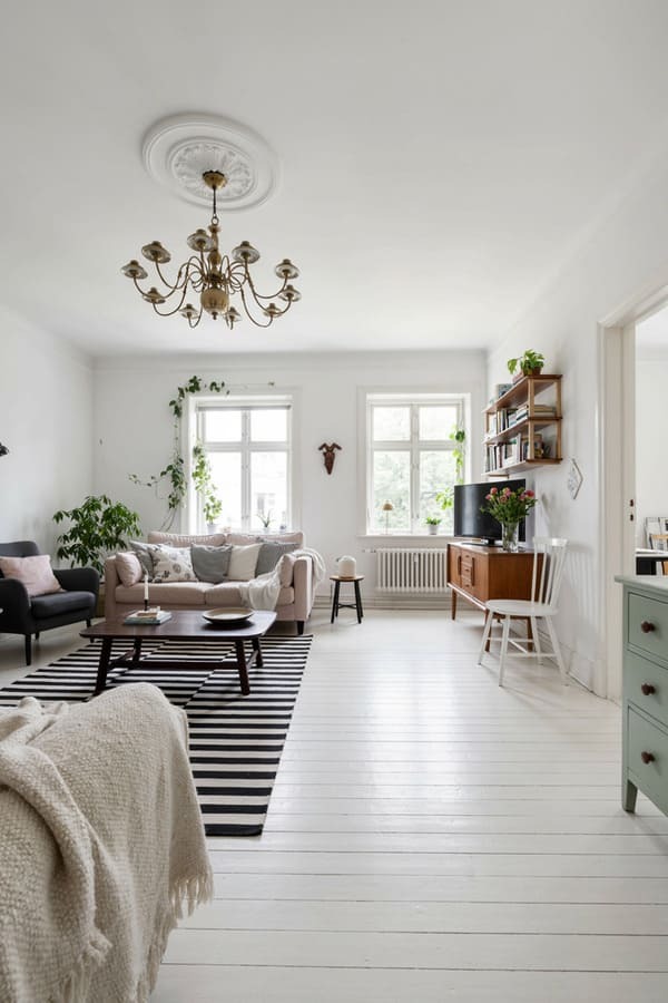 Bright studio apartment with the bed tucked into a separate sleeping area