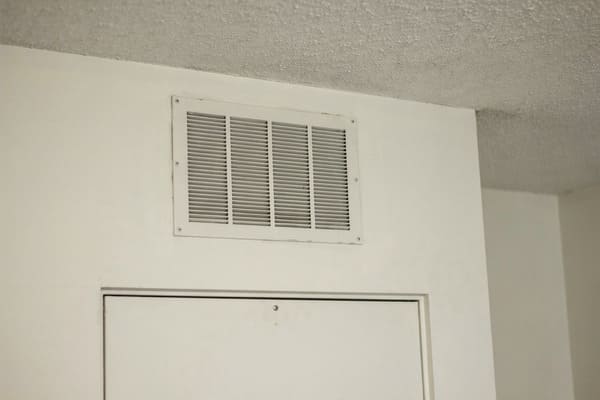 Air vent near the ceiling inside a home.