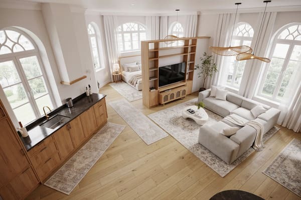 Open studio apartment layout with a bookshelf dividing the bed and living area