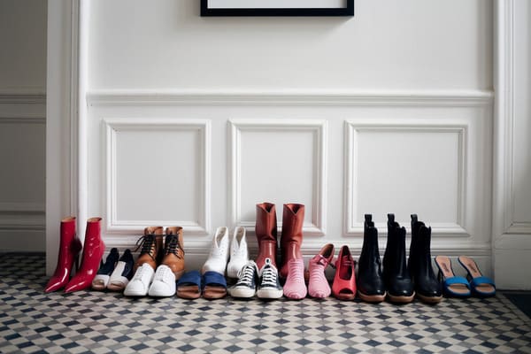 Outdoor shoes lined up by the entryway of a home