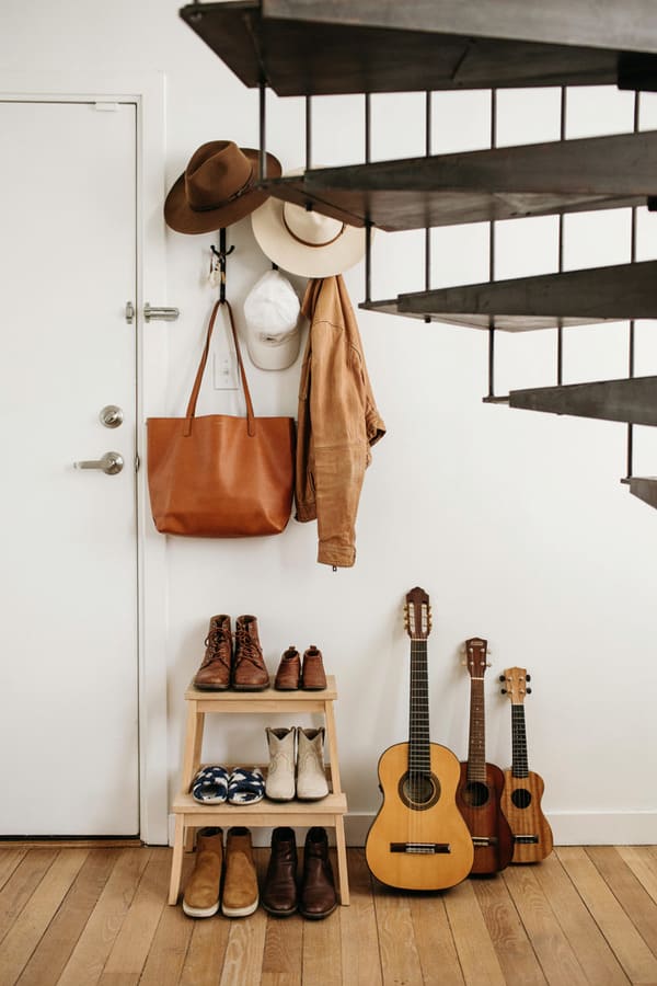 Organized shoe storage beside a home entryway
