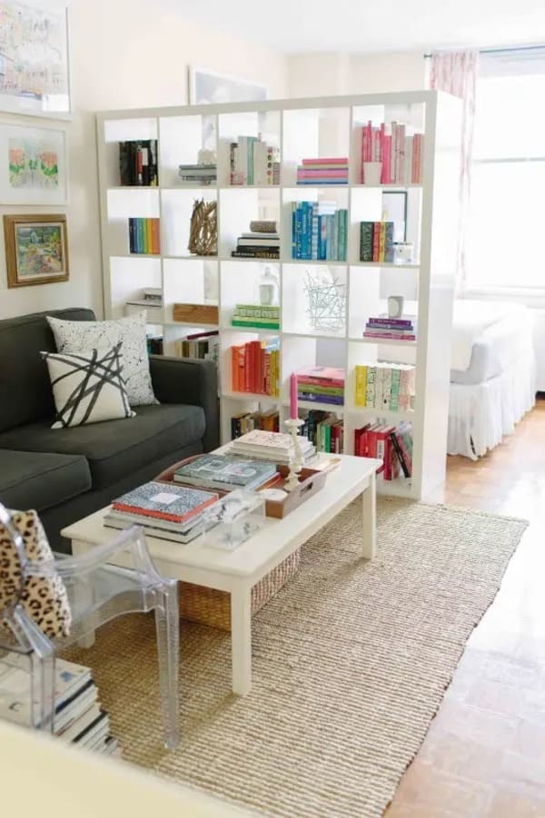 Bookshelf used as a bedroom divider in a studio apartment