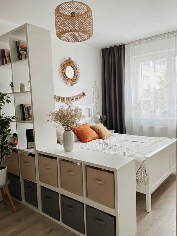 Storage shelving used to divide the bedroom and living area in a studio apartment