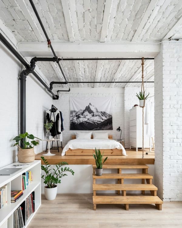 Elevated platform creating a separate bedroom zone in a studio apartment