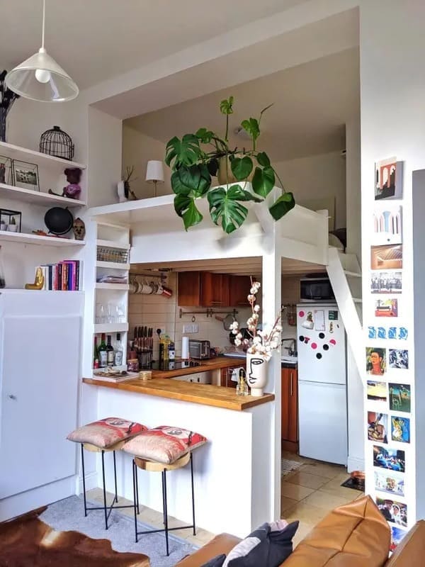 Loft bed above a kitchen in a small studio apartment