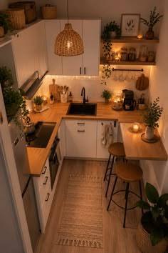 Cozy small kitchen with warm under-shelf lighting, wood counters and breakfast stools