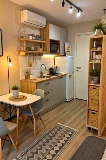 Narrow apartment kitchen with tall rolling storage shelf beside the refrigerator