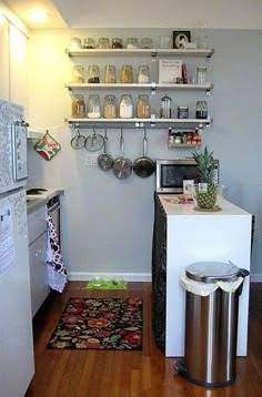 Tiny kitchen wall storage with open shelves and hanging pots and pans